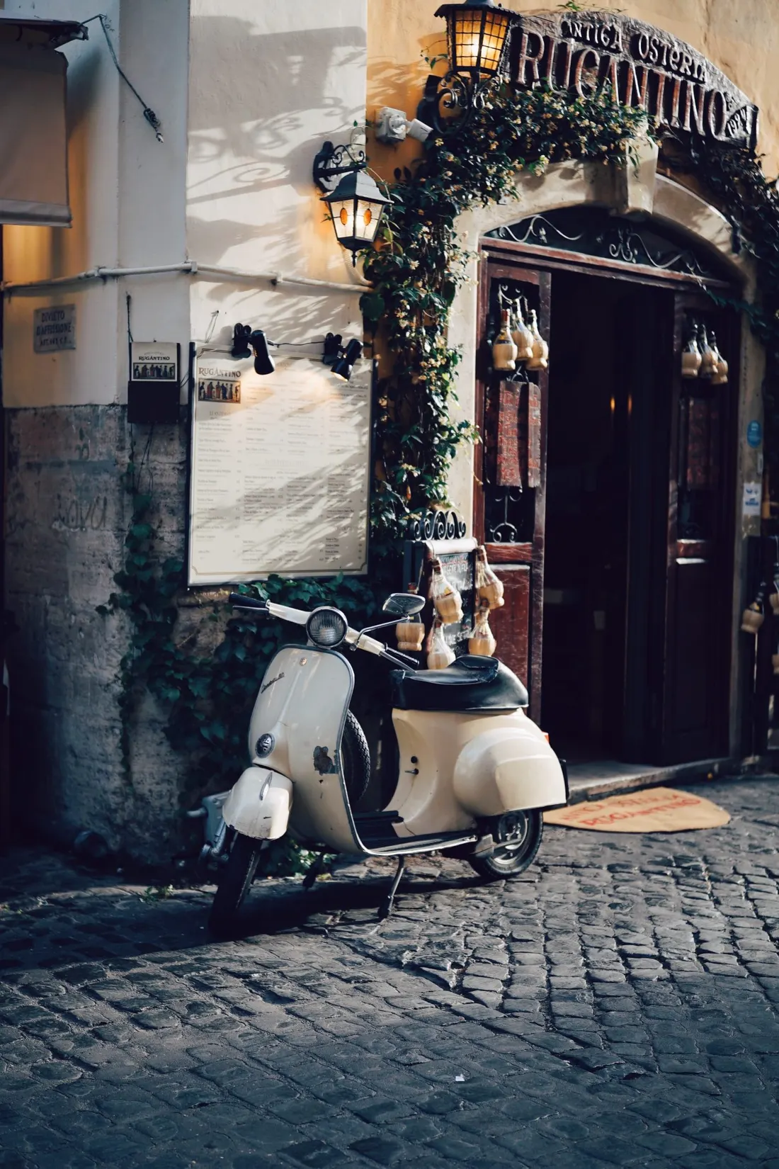 A vespa parked in a cobbled Italian lane